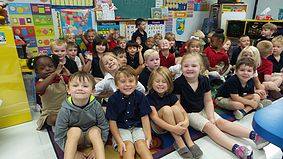 845c77_9836c6daf7654d1abb0f51eda3a0b669.jpg Children gathering for a photo